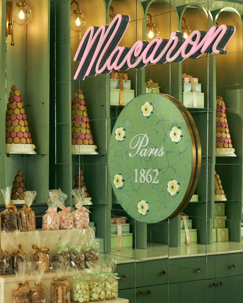 Luxurious French patisserie display counter featuring fresh eclairs, tarts, viennoiseries, croissants, and macarons inside Ladurée restaurant Arkan Plaza